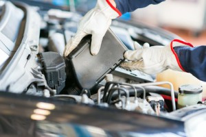 Auto mechanic changing motor oil